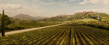 Movie still from “Hitman's Wife's Bodyguard” (2021), directed by Patrick Hughes – An aerial view of a field of crops and a road; Extreme Wide shot, High angle