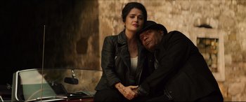 Movie still from “Hitman's Wife's Bodyguard” (2021), directed by Patrick Hughes – A man and a woman sitting next to each other; Medium shot, High angle