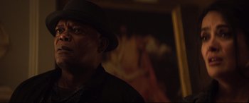 Movie still from “Hitman's Wife's Bodyguard” (2021), directed by Patrick Hughes – A person wearing a hat; Close Up shot, Low angle