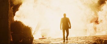 Movie still from “Hitman's Wife's Bodyguard” (2021), directed by Patrick Hughes – A man in a suit walking in front of a fire truck; Wide shot, Low angle