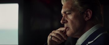 Movie still from “Hitman's Wife's Bodyguard” (2021), directed by Patrick Hughes – A person with his hand to his chin; Close Up shot, Low angle