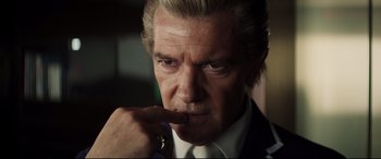 Movie still from “Hitman's Wife's Bodyguard” (2021), directed by Patrick Hughes – A person wearing a suit and tie; Close Up shot, Low angle