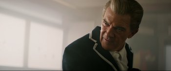 Movie still from “Hitman's Wife's Bodyguard” (2021), directed by Patrick Hughes – An older man in a black jacket looking at the camera; Close Up shot, Low angle