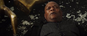 Movie still from “Hitman's Wife's Bodyguard” (2021), directed by Patrick Hughes – A man laying on the ground with his eyes wide open; Close Up shot, Low angle