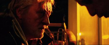 Movie still from “Hobo with a Shotgun” (2011), directed by Jason Eisener – A person with a beard; Close Up shot, Low angle