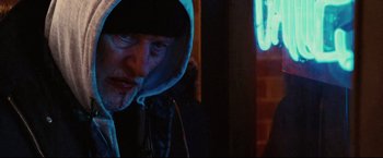 Movie still from “Hobo with a Shotgun” (2011), directed by Jason Eisener – A man in a hooded jacket is looking at the camera; Close Up shot, Low angle