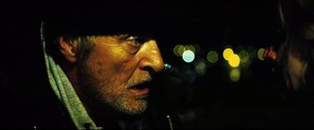 Movie still from “Hobo with a Shotgun” (2011), directed by Jason Eisener – A person with a hat on; Close Up shot, Over the shoulder angle