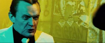 Movie still from “Hobo with a Shotgun” (2011), directed by Jason Eisener – A person in a room; Close Up shot, Low angle