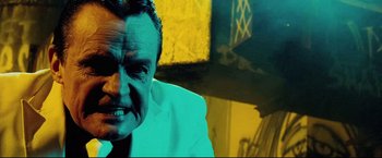 Movie still from “Hobo with a Shotgun” (2011), directed by Jason Eisener – A person wearing a white shirt; Close Up shot, Low angle