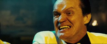 Movie still from “Hobo with a Shotgun” (2011), directed by Jason Eisener – An old man with a very big smile on his face; Close Up shot, Low angle