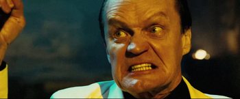 Movie still from “Hobo with a Shotgun” (2011), directed by Jason Eisener – An older man with a frown on his face; Close Up shot, Low angle