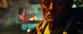 Movie still from “Hobo with a Shotgun” (2011), directed by Jason Eisener – A person wearing a jacket; Close Up shot, Low angle