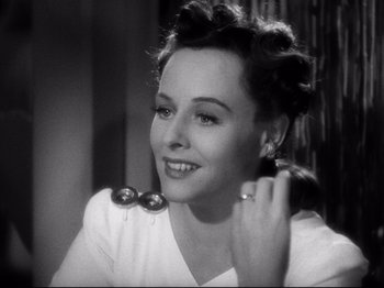 Movie still from “Hold Back the Dawn” (1941), directed by Mitchell Leisen – An old photo of a woman in a white dress; Close Up shot, High angle