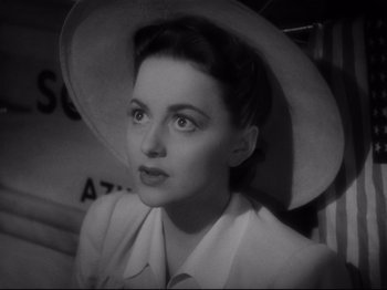 Movie still from “Hold Back the Dawn” (1941), directed by Mitchell Leisen – A black - and - white photo of a woman wearing a hat; Close Up shot, High angle