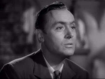Movie still from “Hold Back the Dawn” (1941), directed by Mitchell Leisen – A man wearing a suit and tie looking to his left; Close Up shot, Low angle