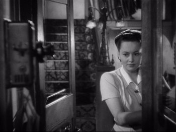 Movie still from “Hold Back the Dawn” (1941), directed by Mitchell Leisen – A black - and - white photo of a woman looking at herself in a mirror; Close Up shot, Over the shoulder angle