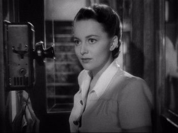 Movie still from “Hold Back the Dawn” (1941), directed by Mitchell Leisen – An old black and white photo of a woman in front of a camera; Close Up shot, High angle