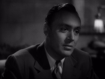 Movie still from “Hold Back the Dawn” (1941), directed by Mitchell Leisen – A man wearing a suit and tie in a black and white photo; Close Up shot, High angle