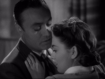 Movie still from “Hold Back the Dawn” (1941), directed by Mitchell Leisen – A man and a woman kissing in a black and white photo; Close Up shot, High angle