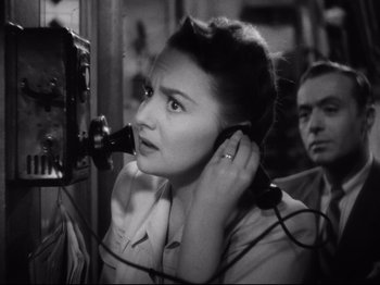 Movie still from “Hold Back the Dawn” (1941), directed by Mitchell Leisen – An old photo of a woman talking on a phone; Close Up shot, High angle