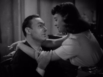 Movie still from “Hold Back the Dawn” (1941), directed by Mitchell Leisen – A man and a woman are holding each other in a room; Close Up shot, High angle