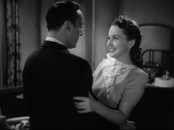 Movie still from “Hold Back the Dawn” (1941), directed by Mitchell Leisen – A man and a woman are smiling and holding each other; Close Up shot, High angle