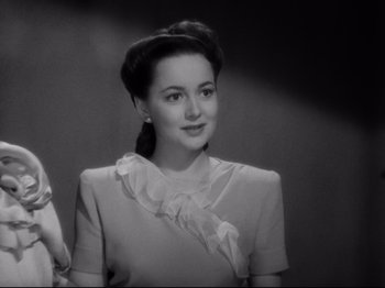 Movie still from “Hold Back the Dawn” (1941), directed by Mitchell Leisen – A black - and - white photo of a woman in a dress; Close Up shot, Low angle