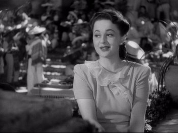 Movie still from “Hold Back the Dawn” (1941), directed by Mitchell Leisen – An old photo of a woman smiling at the camera; Close Up shot, Over the shoulder angle