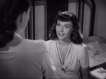 Movie still from “Hold Back the Dawn” (1941), directed by Mitchell Leisen – A black - and - white photo of a woman talking to a man; Close Up shot, Over the shoulder angle