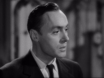 Movie still from “Hold Back the Dawn” (1941), directed by Mitchell Leisen – A man wearing a suit and tie looking to his left; Close Up shot, Low angle