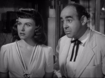 Movie still from “Hold Back the Dawn” (1941), directed by Mitchell Leisen – A man and a woman standing next to each other; Close Up shot, High angle