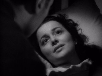 Movie still from “Hold Back the Dawn” (1941), directed by Mitchell Leisen – A black - and - white photo of a woman looking up; Close Up shot, High angle