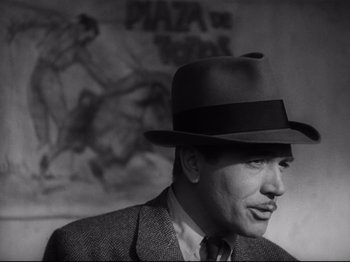 Movie still from “Hold Back the Dawn” (1941), directed by Mitchell Leisen – A black and white photo of a man wearing a hat; Close Up shot, Low angle