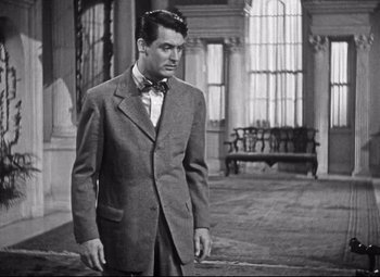 Movie still from “Holiday” (1938), directed by George Cukor – A black and white photo of a man in a suit; Medium shot, Over the shoulder angle