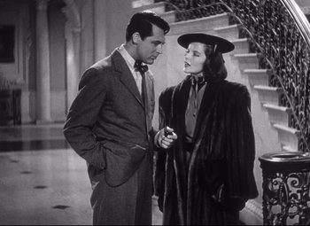 Movie still from “Holiday” (1938), directed by George Cukor – A man and a woman standing next to each other; Medium shot, Low angle