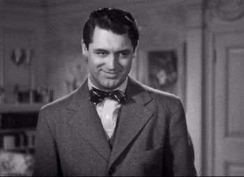 Movie still from “Holiday” (1938), directed by George Cukor – A man wearing a suit and a bow tie; Close Up shot, Over the shoulder angle