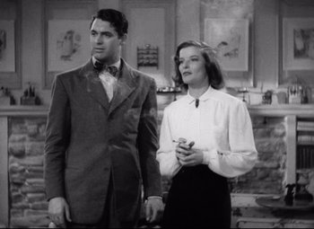 Movie still from “Holiday” (1938), directed by George Cukor – A man and a woman standing next to each other in a room; Medium shot, Low angle