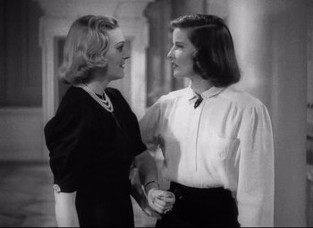 Movie still from “Holiday” (1938), directed by George Cukor – A couple of women standing next to each other; Medium shot, Low angle
