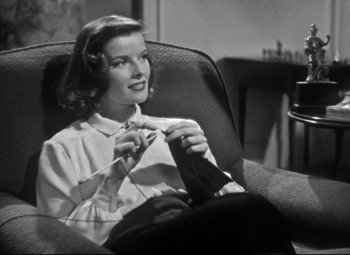 Movie still from “Holiday” (1938), directed by George Cukor – A black and white photo of a woman knitting; Medium shot, High angle