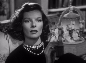 Movie still from “Holiday” (1938), directed by George Cukor – An old photo of a woman holding a glass of wine; Close Up shot, Low angle