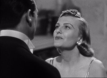 Movie still from “Holiday” (1938), directed by George Cukor – A man and a woman are talking to each other; Close Up shot, Over the shoulder angle