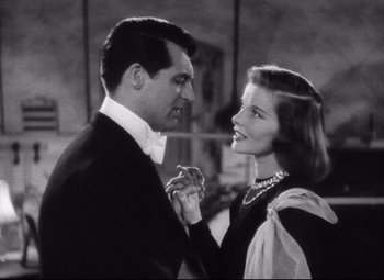 Movie still from “Holiday” (1938), directed by George Cukor – A man and a woman standing next to each other; Close Up shot, Low angle