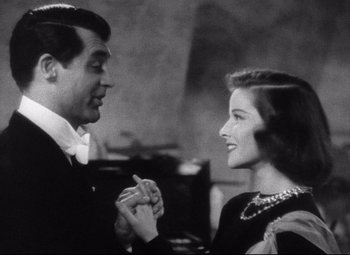 Movie still from “Holiday” (1938), directed by George Cukor – A man and a woman talking to each other; Close Up shot, Low angle