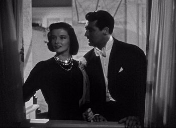 Movie still from “Holiday” (1938), directed by George Cukor – A man and a woman standing next to each other; Medium shot, High angle