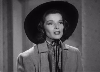 Movie still from “Holiday” (1938), directed by George Cukor – A black and white photo of a woman wearing a hat; Close Up shot, Low angle