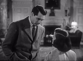 Movie still from “Holiday” (1938), directed by George Cukor – A man and a woman are looking at one another; Medium shot, Low angle