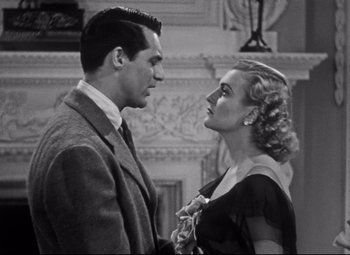 Movie still from “Holiday” (1938), directed by George Cukor – A man and a woman standing next to each other; Medium shot, Low angle