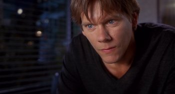 Movie still from “Hollow Man” (2000), directed by Paul Verhoeven – A person wearing a black t - shirt; Close Up shot, High angle