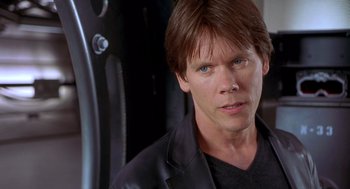 Movie still from “Hollow Man” (2000), directed by Paul Verhoeven – A person wearing a black jacket; Close Up shot, Over the shoulder angle