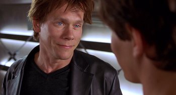 Movie still from “Hollow Man” (2000), directed by Paul Verhoeven – A man in a leather jacket talking to another man in a leather jacket; Close Up shot, Over the shoulder angle